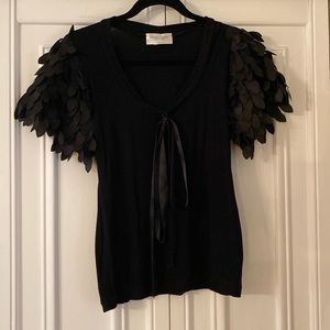 Fancy top with incredible leaf like sleeves.
